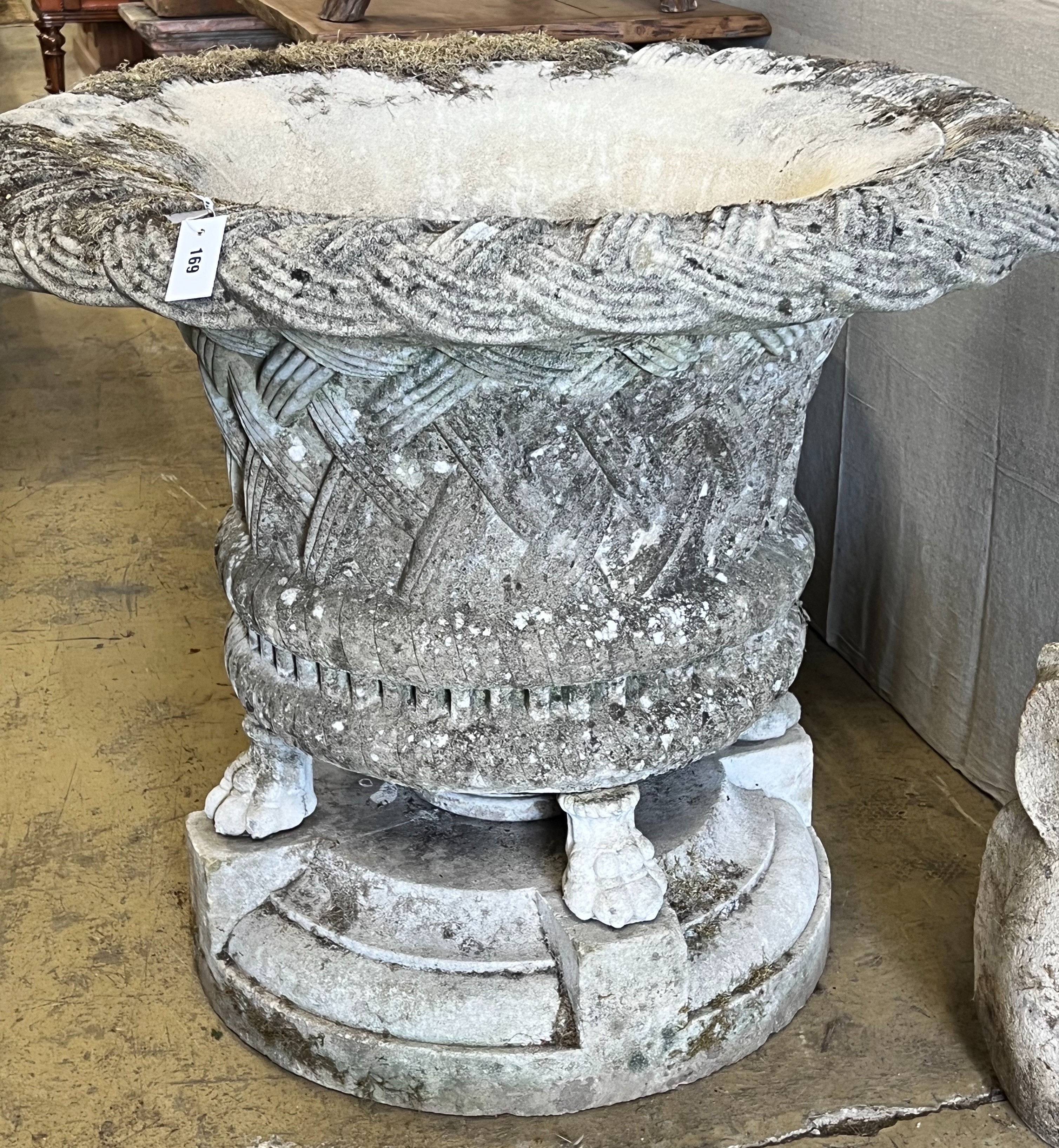 A large reconstituted stone basketweave garden urn on lions paw feet, diameter 104cm height 86cm